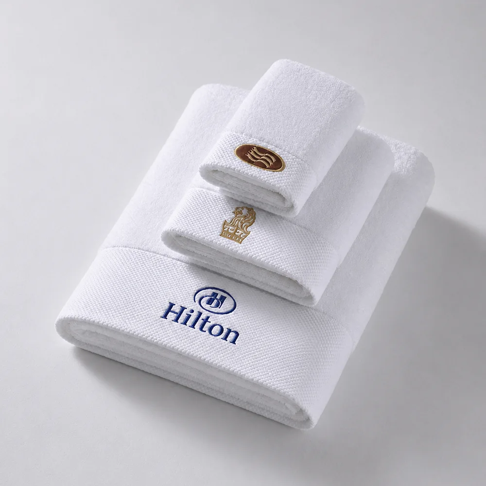 Premium white bath towels arranged in a hotel bathroom