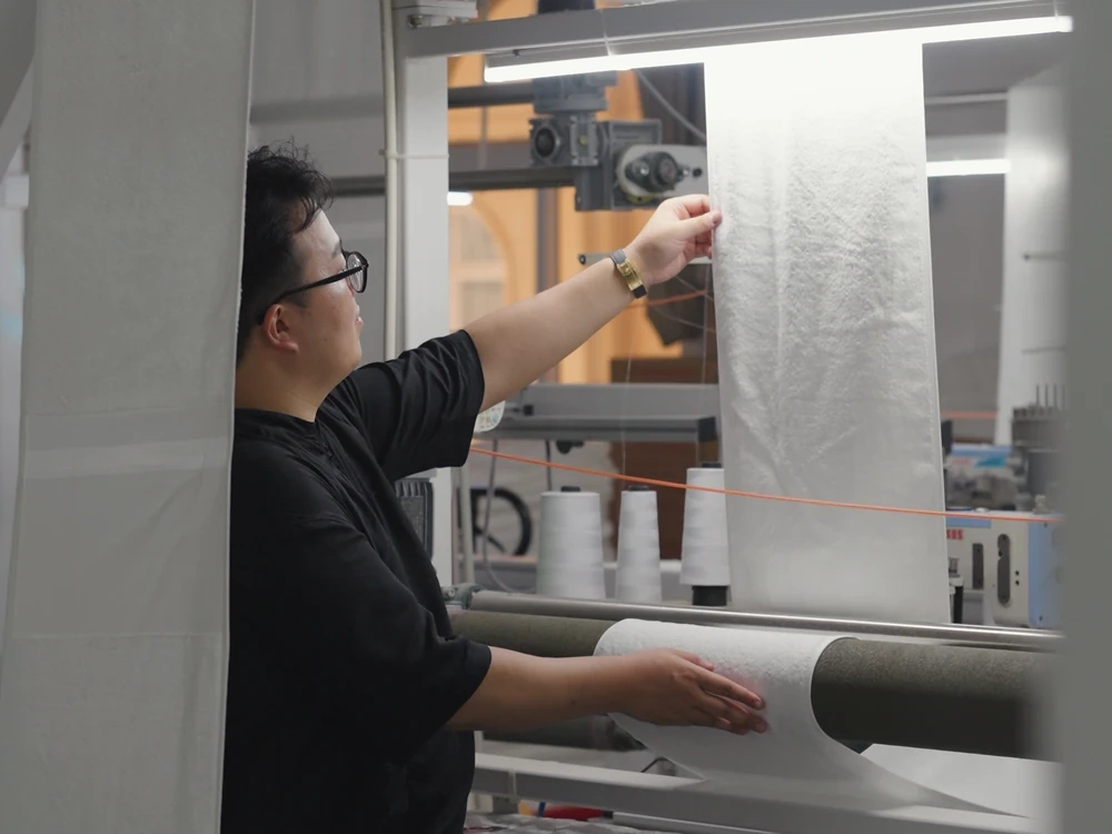 Textile manufacturing machinery operating inside a production facility