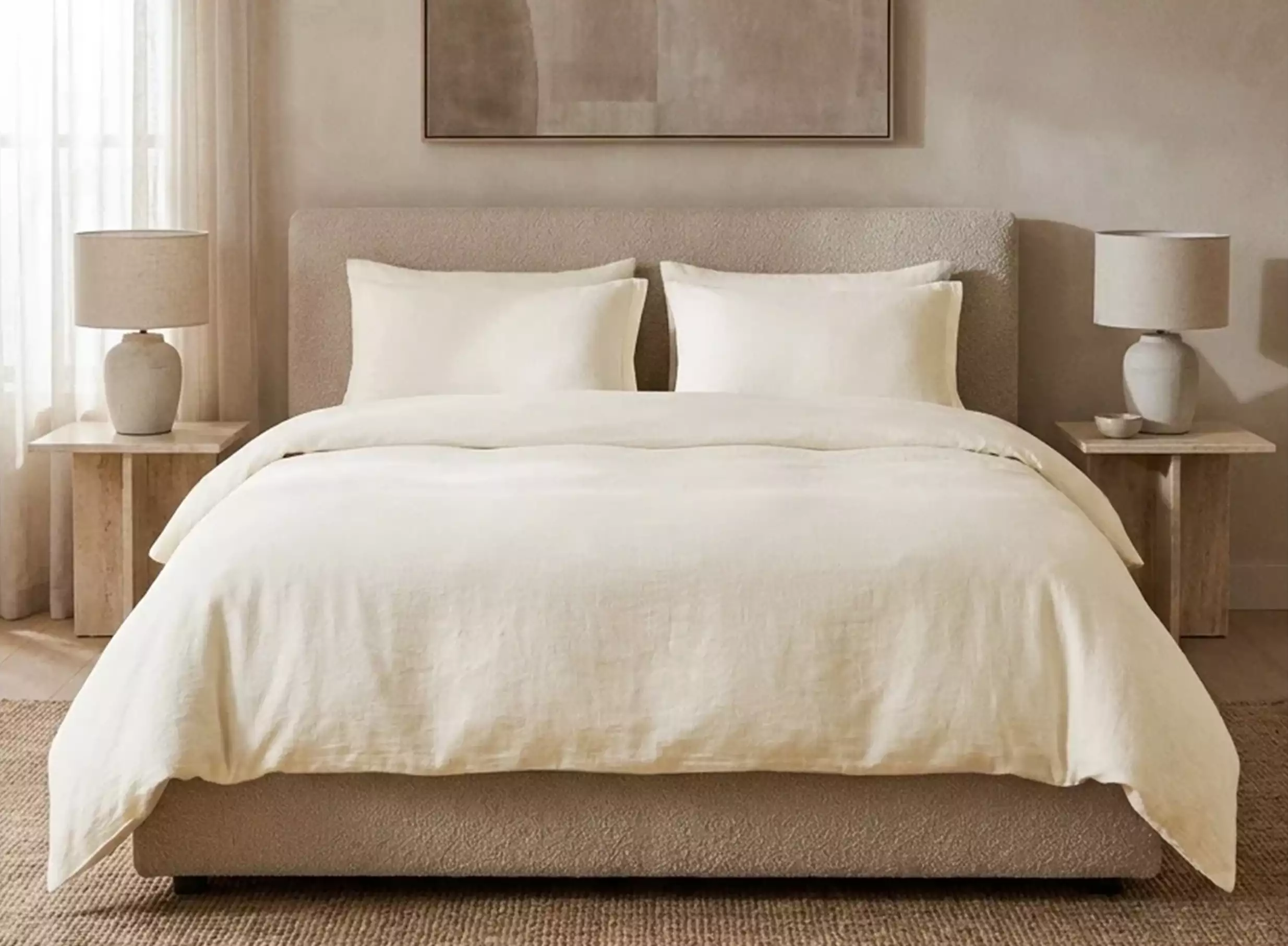 Hotel-inspired bedding and soft home textiles arranged in a refined bedroom